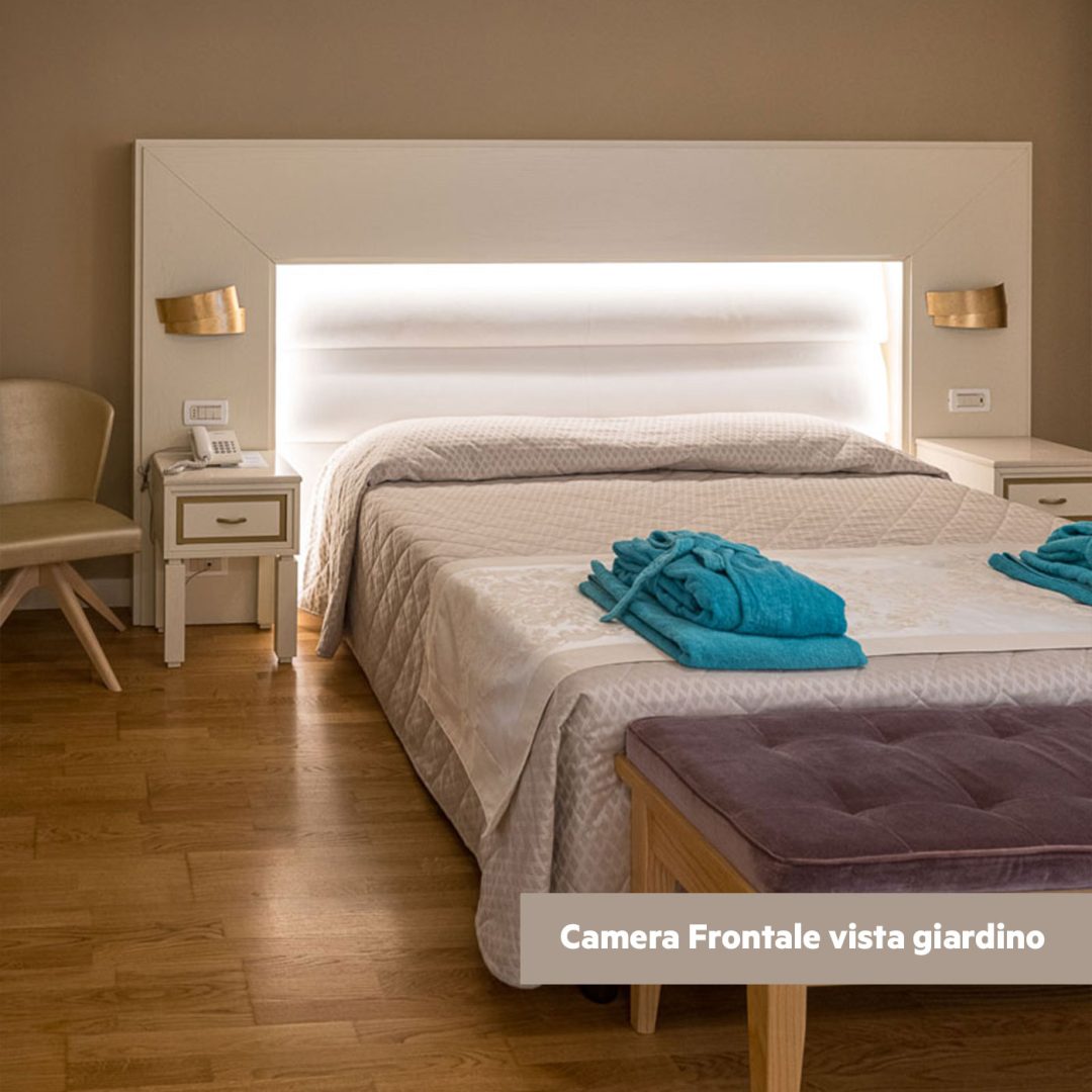 Letto matrimoniale con illuminazione integrata nella testata.